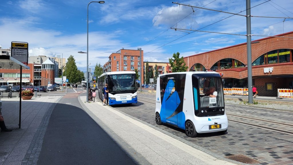 Auve Tech autonomous bus on the road with a public transport bus